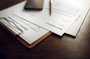 Image of a bank statement and loan application form.